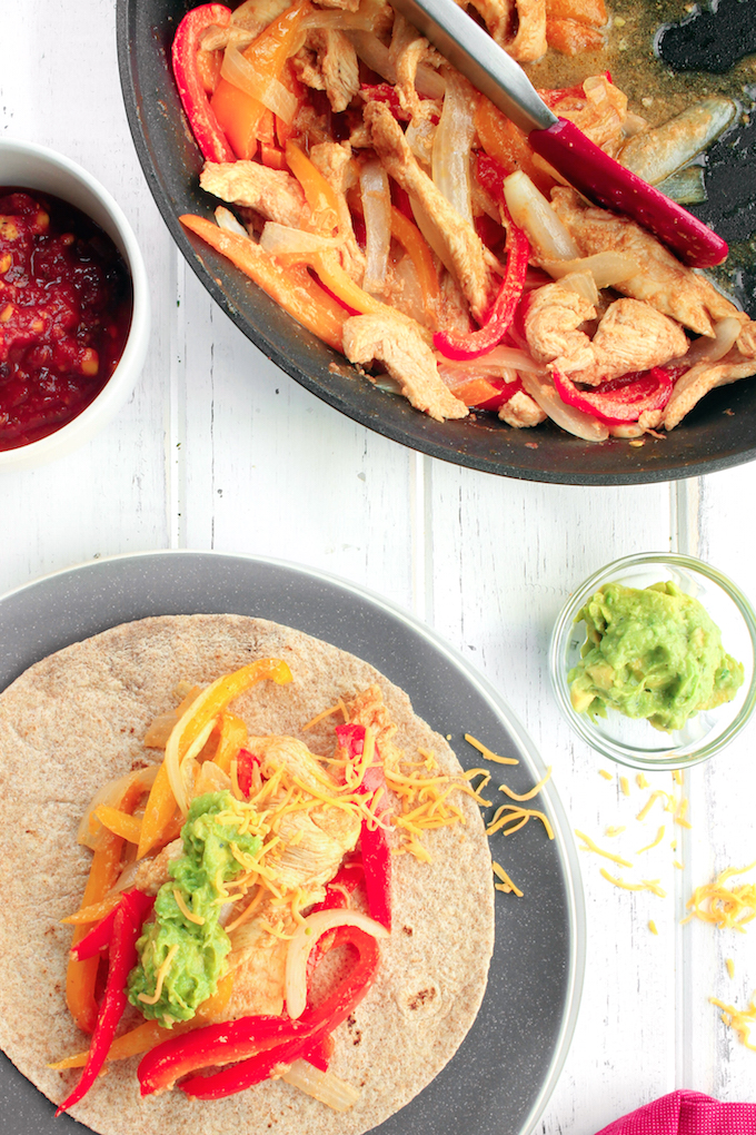 Freezer-Friendly Fajita Kits with marinated chicken, chopped peppers and onions, shredded cheese and whole-wheat tortillas. Top with salsa and guacamole for the ultimate make-ahead Mexican feast.
