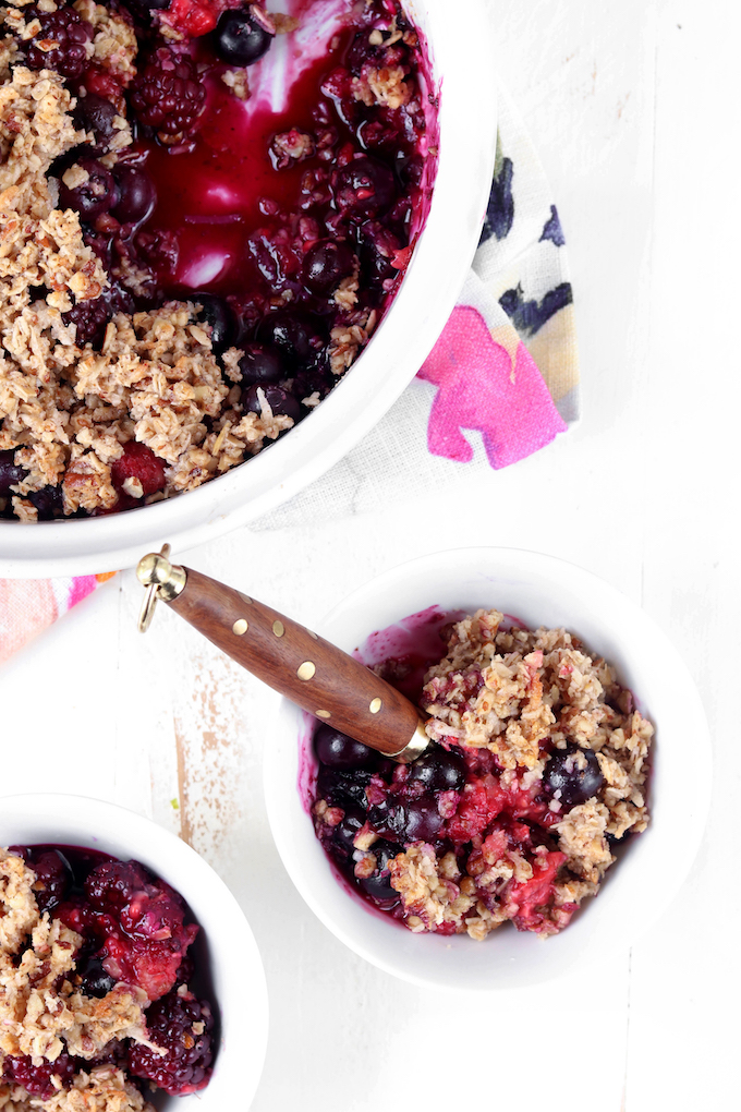 The best triple berry crisp, naturally sweetened and gluten free. Bubbly, warm fruit and crispy granola topping!