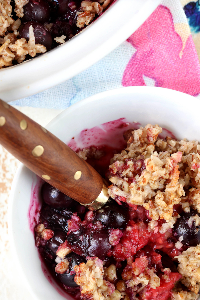 The best triple berry crisp, naturally sweetened and gluten free. Bubbly, warm fruit and crispy granola topping!