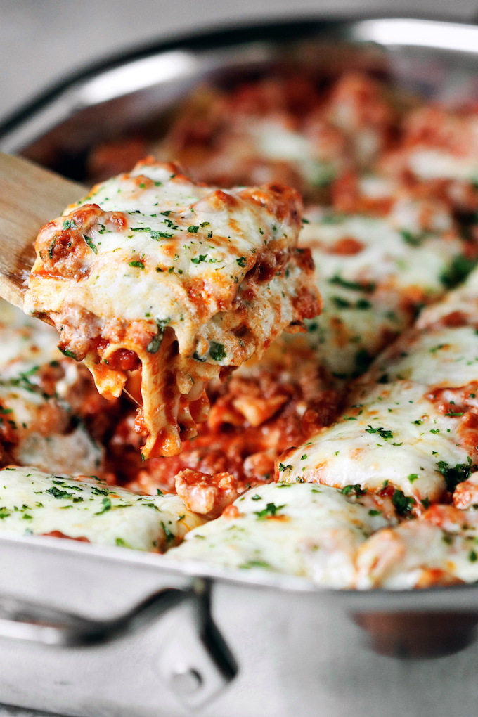 Flavorful, Clean Eating Lasagna with a zesty meat sauce, creamy ricotta and melty mozzarella. Freezer Friendly and so delicious!