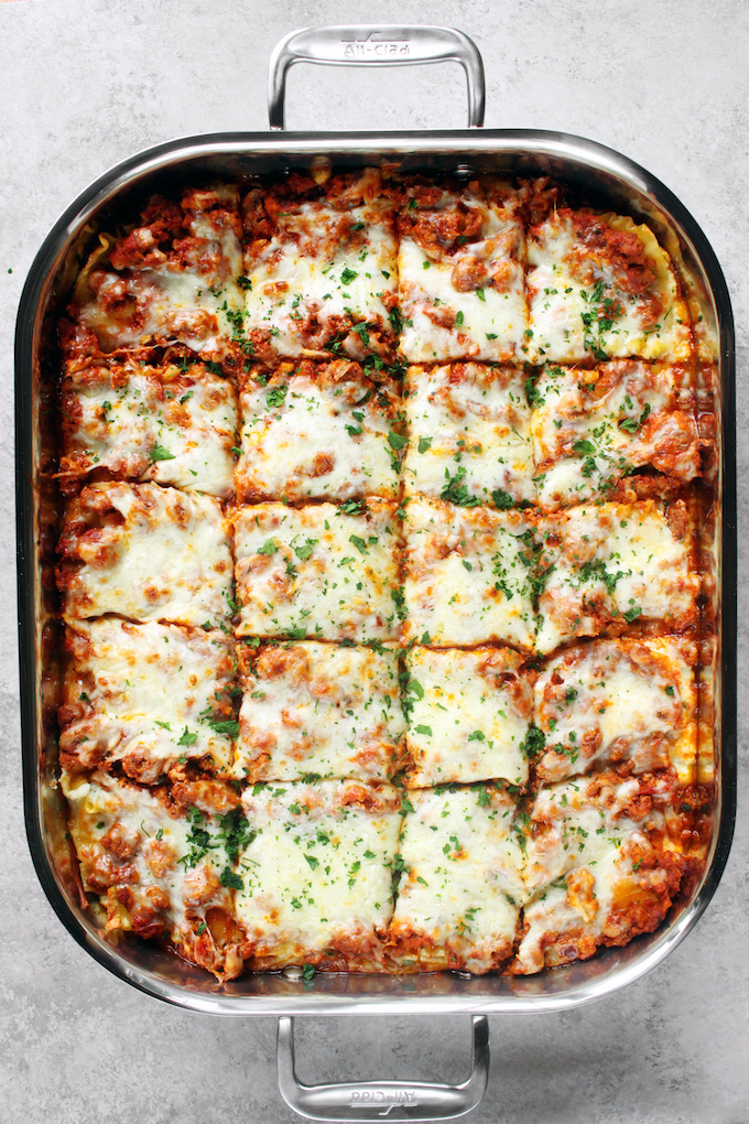 Flavorful, Clean Eating Lasagna with a zesty meat sauce, creamy ricotta and melty mozzarella. Freezer Friendly and so delicious!