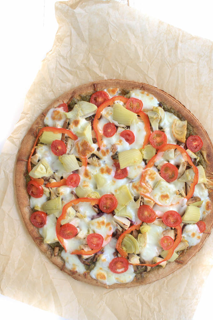 Whole wheat lavash bread, topped with creamy basil pesto sauce, seasoned chicken, garden fresh heirloom tomatoes, caramelized onions, zesty artichokes, and melted mozzarella cheese... AKA Chicken Pesto Pizza???