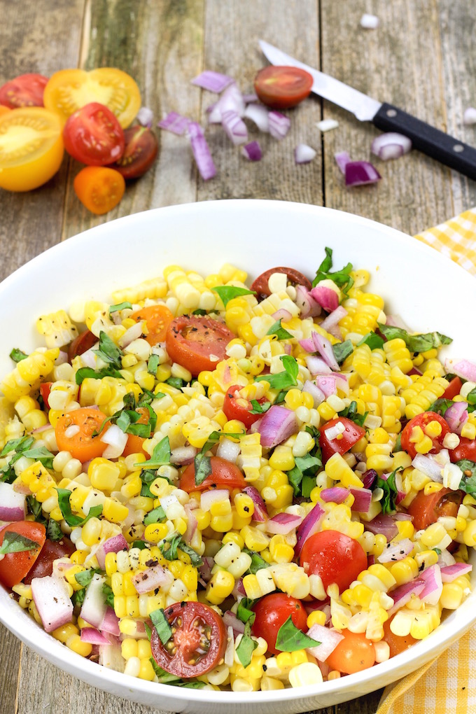 Simple Corn Salad with cherry tomatoes and fresh basil is simple to make, requiring just 1 bowl and 6 ingredients. Tender corn, juicy tomatoes and red onion dressed in a tangy homemade vinaigrette create Summer side dish perfection.