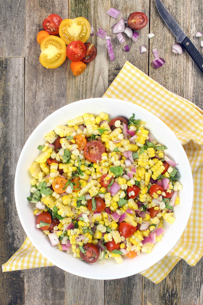 Simple Corn Salad with cherry tomatoes and fresh basil is simple to make, requiring just 1 bowl and 6 ingredients. Tender corn, juicy tomatoes and red onion dressed in a tangy homemade vinaigrette create Summer side dish perfection.