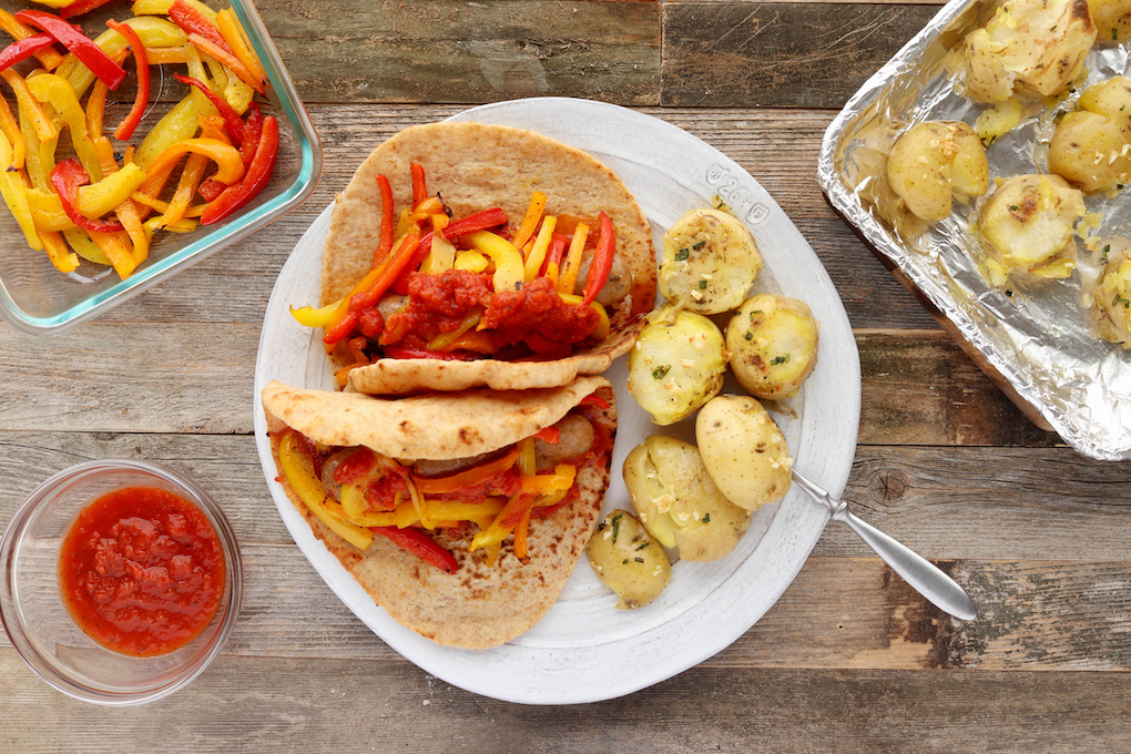 Italian Sausage Gyros are simple to make, requiring just 10 minutes hands on prep. Spicy Italian Chicken Sausage, tender roasted red bell peppers and sweet onions wrapped in a whole-wheat pita with melty mozzarella and marinara, sheet pan supper has never tasted better!