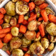 Maple Dijon Roasted Carrots and Brussel Sprouts in a white bowl.
