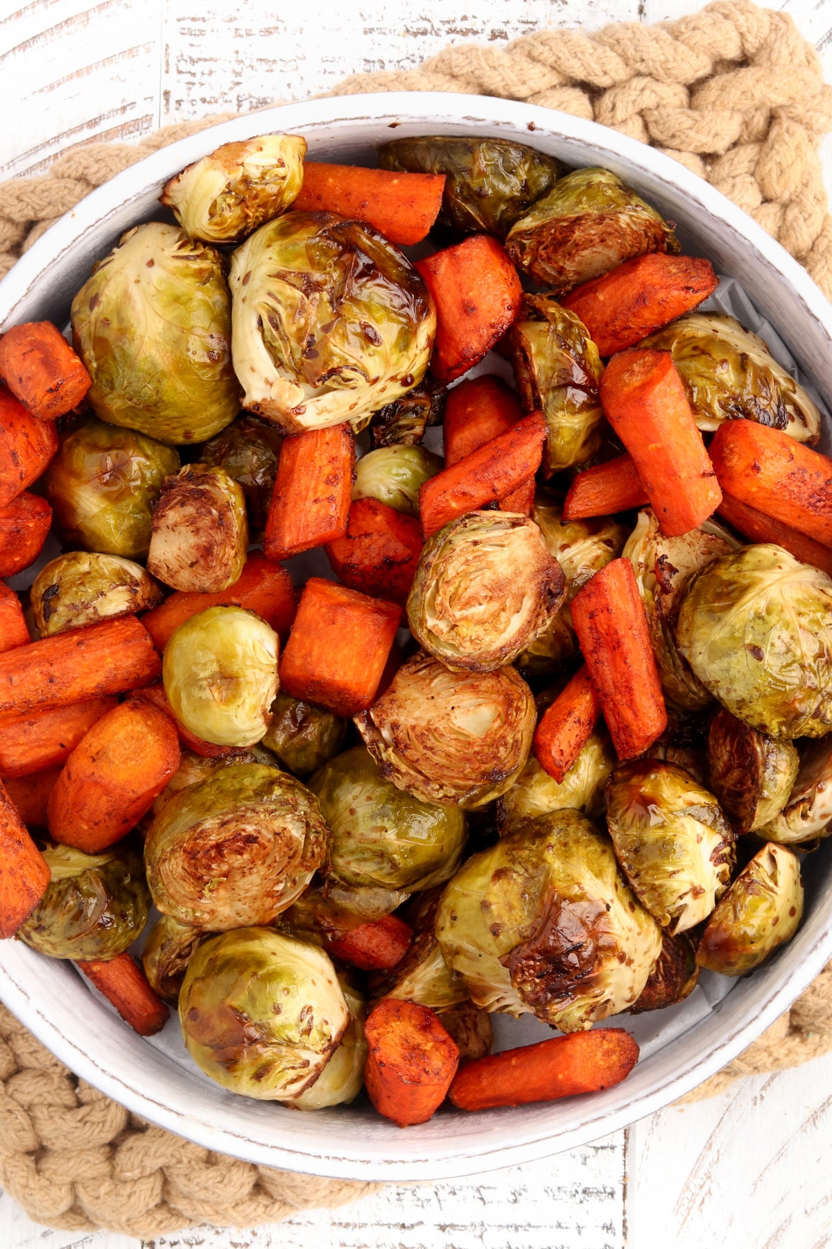 Maple Dijon Roasted Carrots and Brussel Sprouts in a white bowl. 