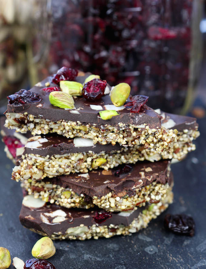 Simple 2 layer Superfood Dark Chocolate Quinoa Bark: crunchy toasted nuts and seeds held together with pure maple syrup on the bottom and decadent dark chocolate studded with cranberries, sliced almonds and pistachios on the top.