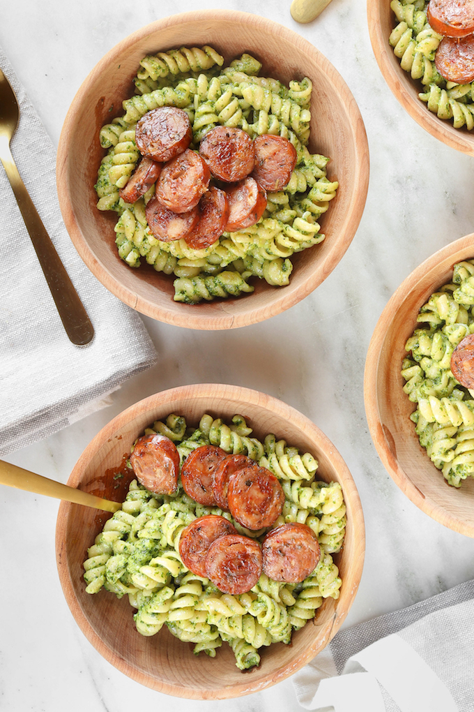 Winter Pesto Pasta with Italian Sausage in 3 wooden bowls.