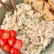 3 Ingredient Chicken Salad in a green serving bowl with tomatoes and rosemary crackers.