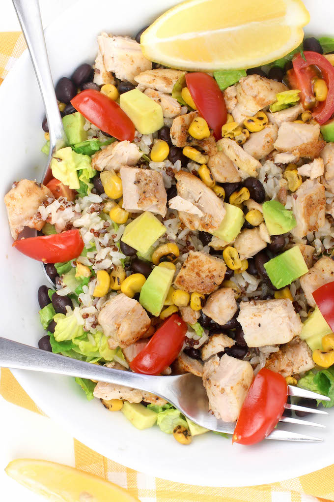 This 30-Minute Healthy Chicken Burrito Bowl starts with a layer of leafy romaine and is topped with whole-food ingredients like black beans, fire roasted corn, seasoned quinoa, creamy avocado and juicy tomatoes.