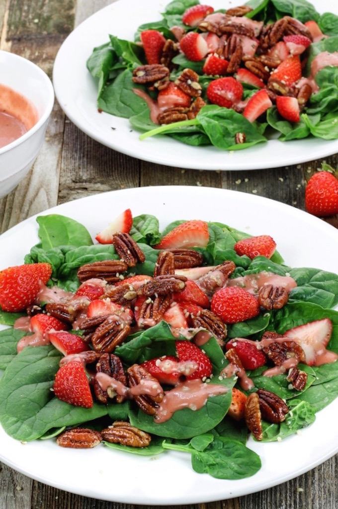 A simple spinach salad with loads of crunchy sweet pecans and fresh juicy strawberries, all dressed in a homemade tangy-sweet creamy vegan dressing.