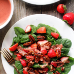 A simple spinach salad with loads of crunchy sweet pecans and fresh juicy strawberries, all dressed in a homemade tangy-sweet creamy vegan dressing.