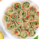 Delicious, vegan friendly Roasted-Red Pepper Italian Pinwheels come together in 15 minutes with 9 ingredients. It's the perfect crowd-pleasing summer appetizer. #vegan #glutenfree #plantbased #wholefood