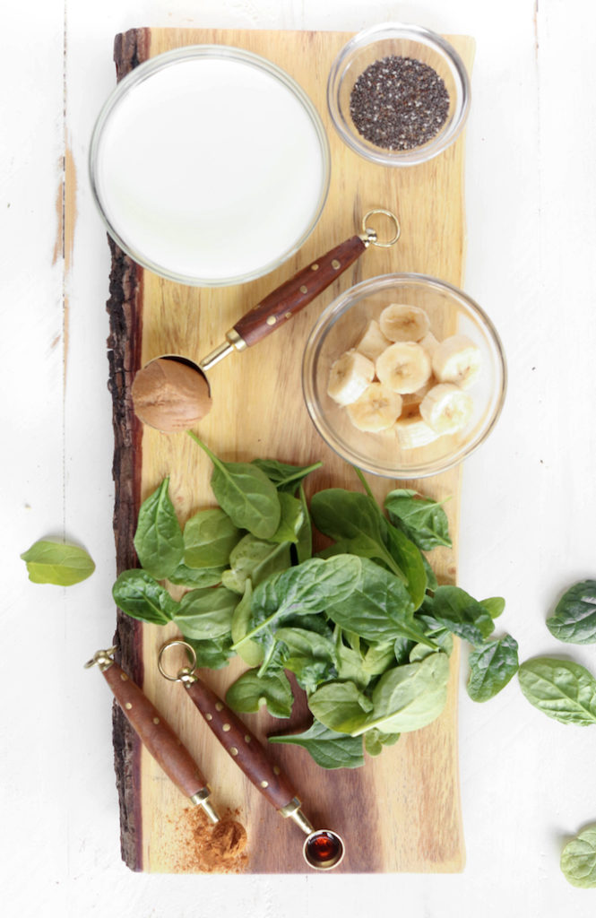 A cool, creamy, sweet vegan green smoothie with banana, peanut butter, kale, chia seeds, cinnamon and almond milk.