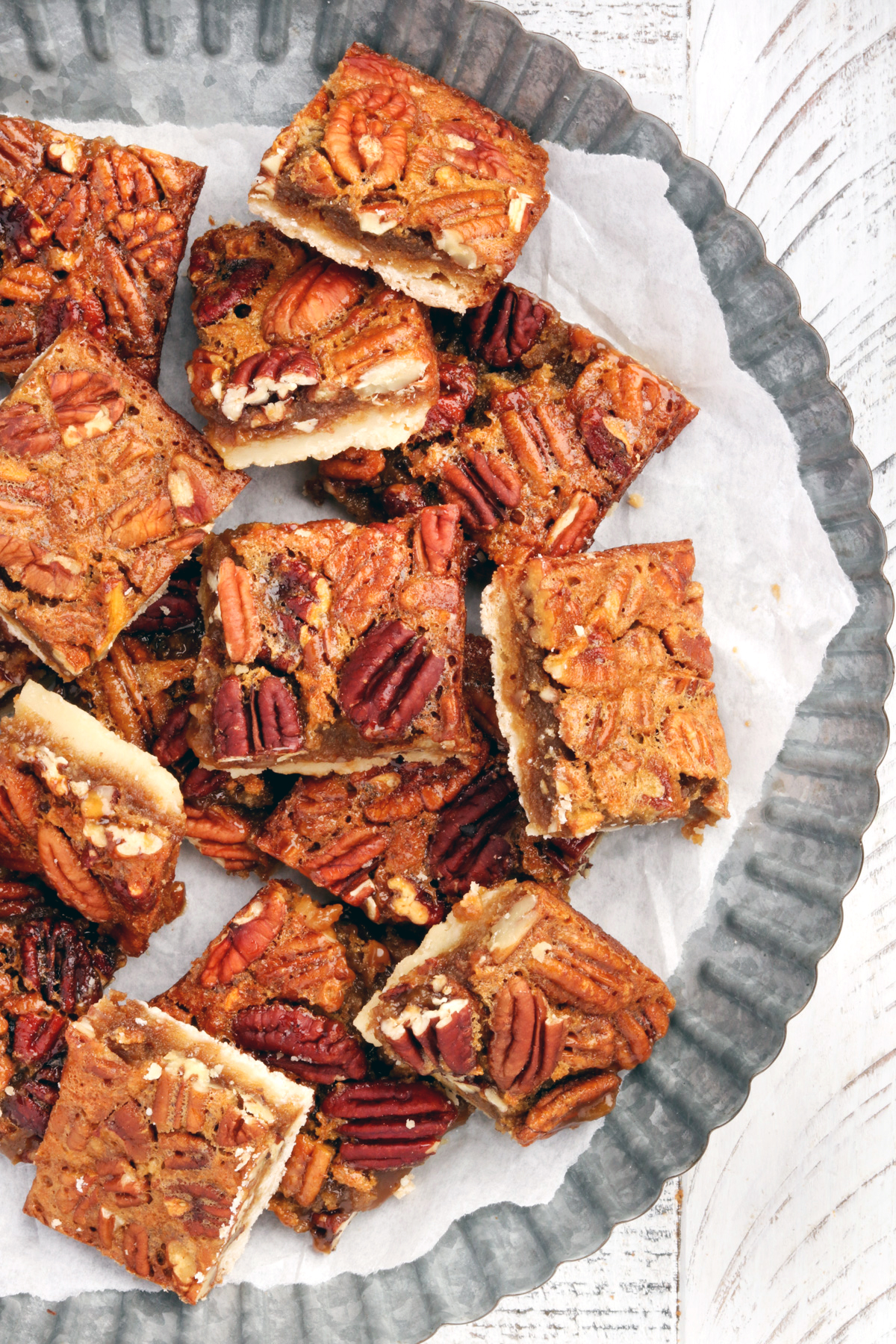 Gluten Free Pecan Pie Bars on a silver cake stand.