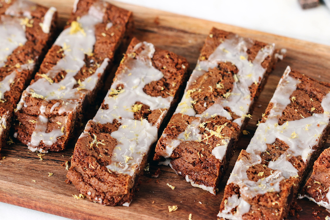 Thick, soft and chewy iced gingerbread bars are studded with dark chocolate chunks and topped off with a simple glaze and hint of lemon. Perfect for the holidays!