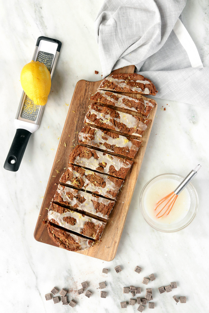 Thick, soft and chewy iced gingerbread bars are studded with dark chocolate chunks and topped off with a simple glaze and hint of lemon. Perfect for the holidays!