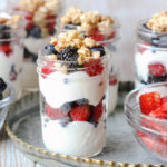 Make Ahead Fruit and Yogurt Parfaits on a silver tray. Strawberries and Berries are in glass bowls.