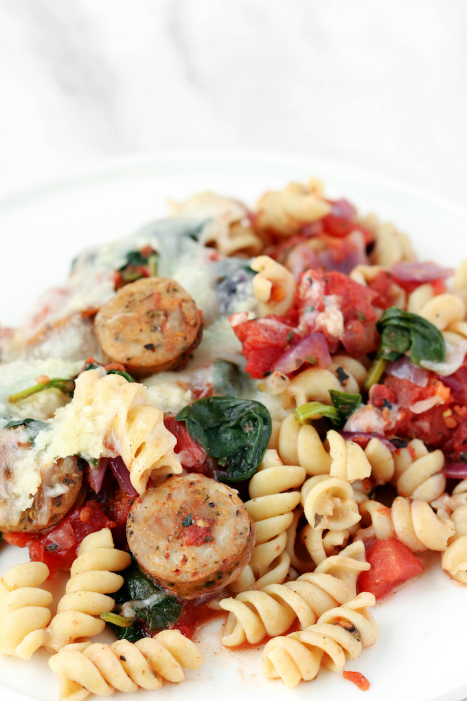 30- Minute Sausage Spinach Rotini Bake with caramelized onion, whole wheat pasta, perfectly seasoned fire roasted tomatoes and a golden cheese topping. Green, delicious, fresh and healthy!