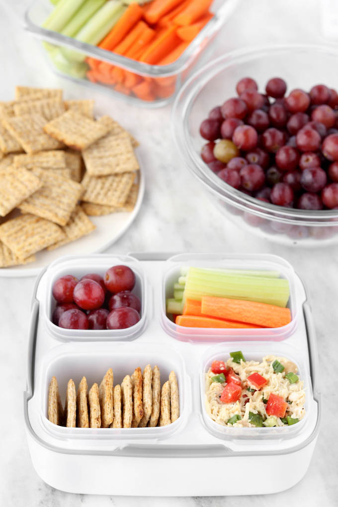 Healthy Chicken Salad.. all of the flavor, less of the mayo! Seasoned chicken, fresh herbs and a simple yogurt-based dressing. Paired with whole-grain crackers, fresh grapes and crispy veggie sticks.