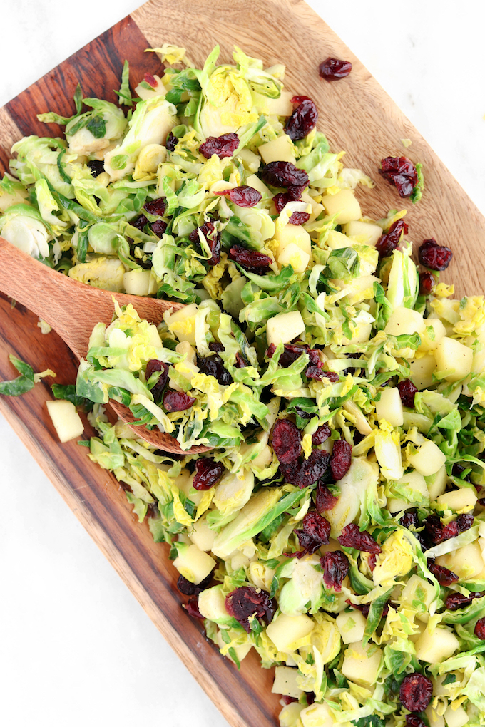  A healthy Cranberry Brussel Slaw loaded with fresh veggies, sweet apples and dressed in a simple lemon and olive oil dressing! Crisp, refreshing and comes together in 15 minutes.