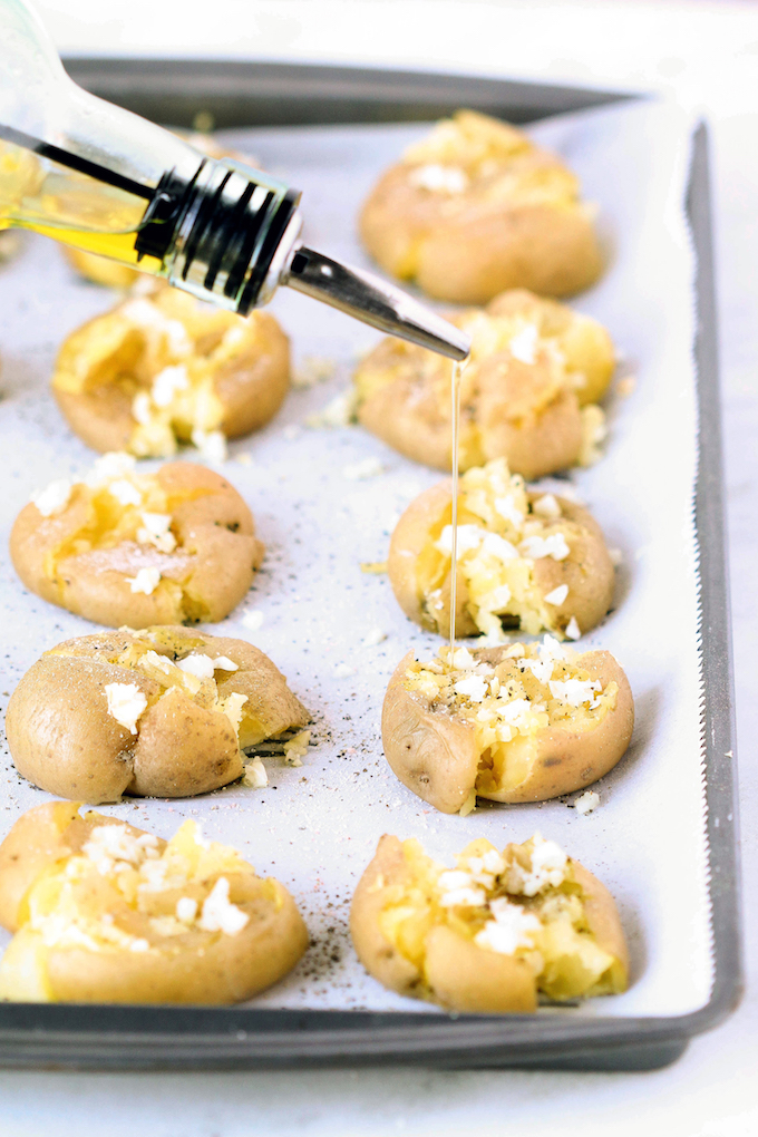 Simple Garlic Smashed Potatoes are the perfect throw dish for busy weeknights. Tender golden potatoes are smashed, topped with olive oil, garlic and thyme and then roasted until crispy. A delicious gluten-free and vegan appetizer or side dish!