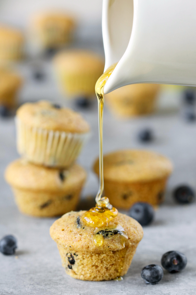 Perfect whole-food Mini Blueberry Corn Muffins made with 9 ingredients! Naturally sweetened, crumbly, tender and studded with bursts of juicy blueberry.