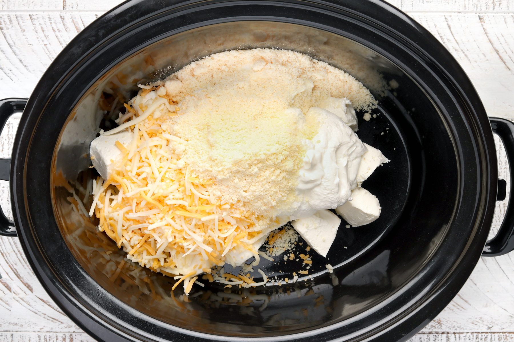 Step 1: Slow Cooker Jalapeno Popper Dip With Bacon. Put the cream cheese, cheddar and parmesan into the slow cooker.