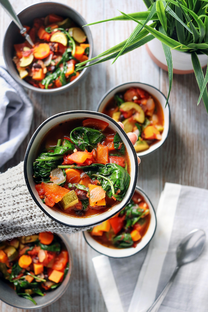 Thick and Chunky Vegetable Soup bowls arranged on a wooden background.