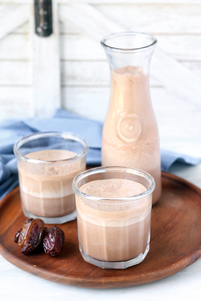 Delicious 6-ingredient Real Food Chocolate Milkshake with cocoa, dates, milk, vanilla and greek yogurt. Frosty, creamy + perfect for a sweet treat!