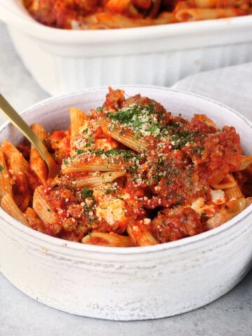 Sausage Baked Penne being served in a white bowl.