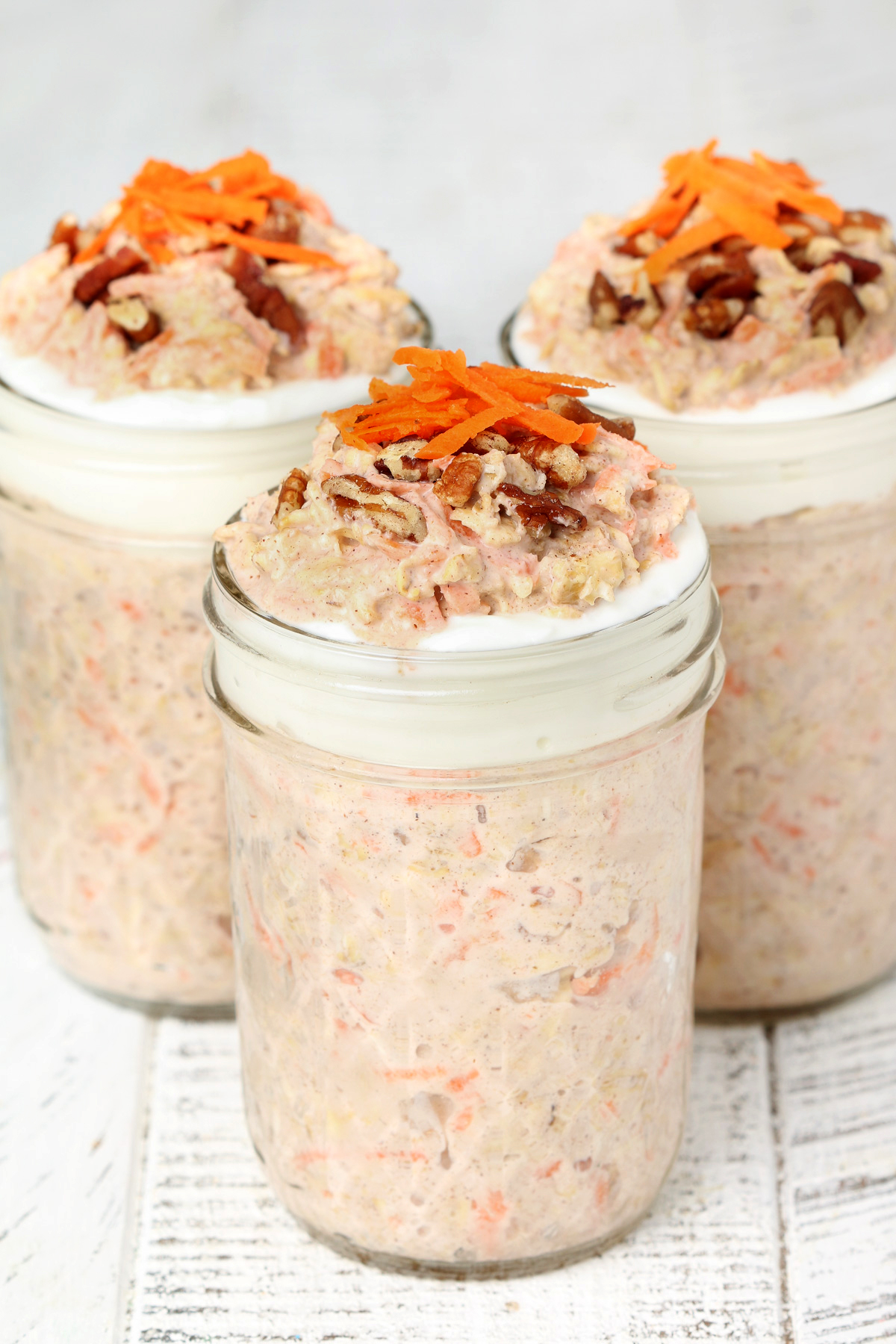 Carrot Cake Overnight Oats topped with yogurt, pecans and grated carrot. 