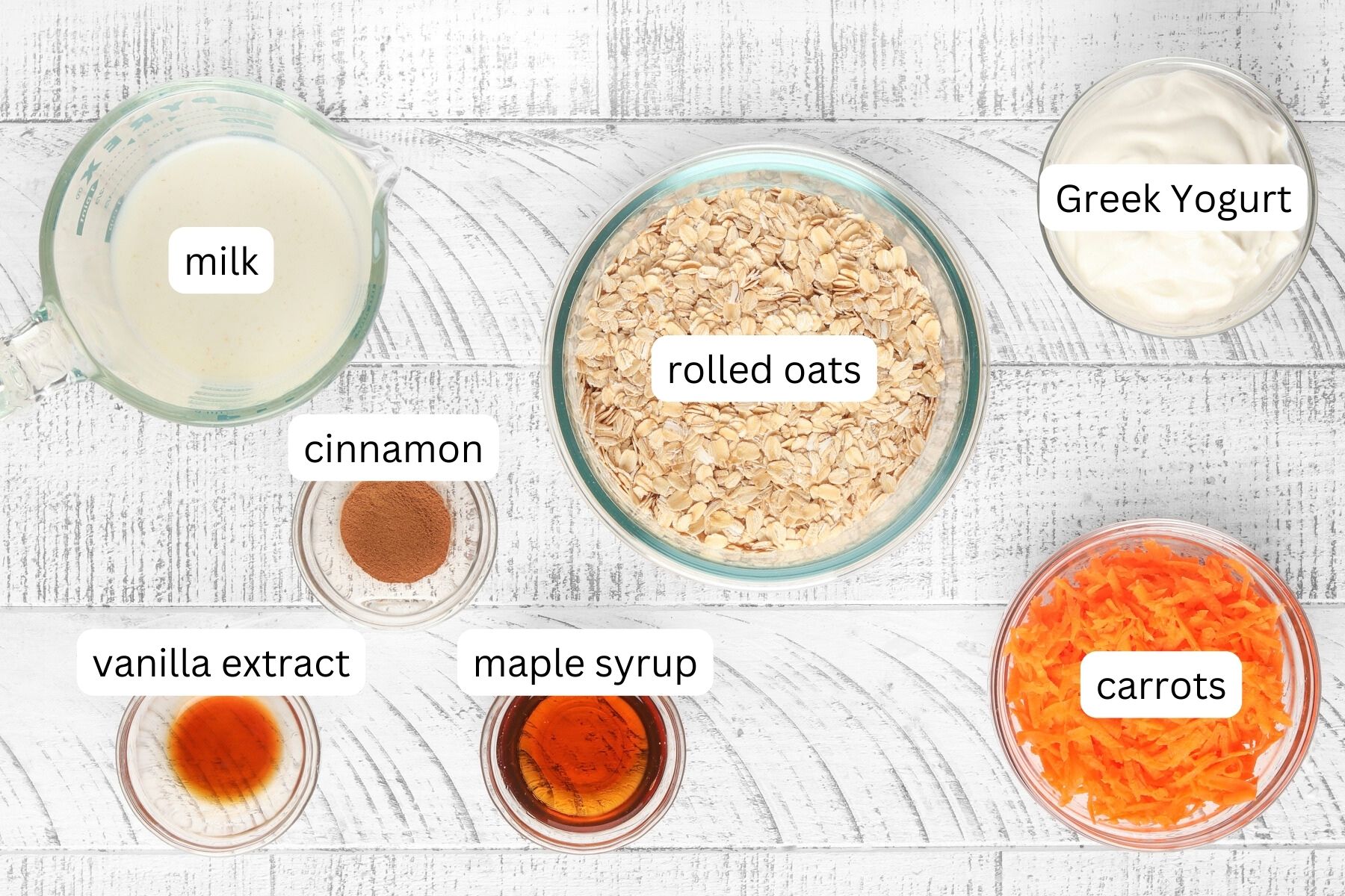 Ingredients for Carrot Cake Overnight Oats - oats, milk, yogurt, maple syrup, vanilla, cinnamon and carrots.