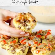 Baked Egg Muffin being lifted into the air from a white plate.