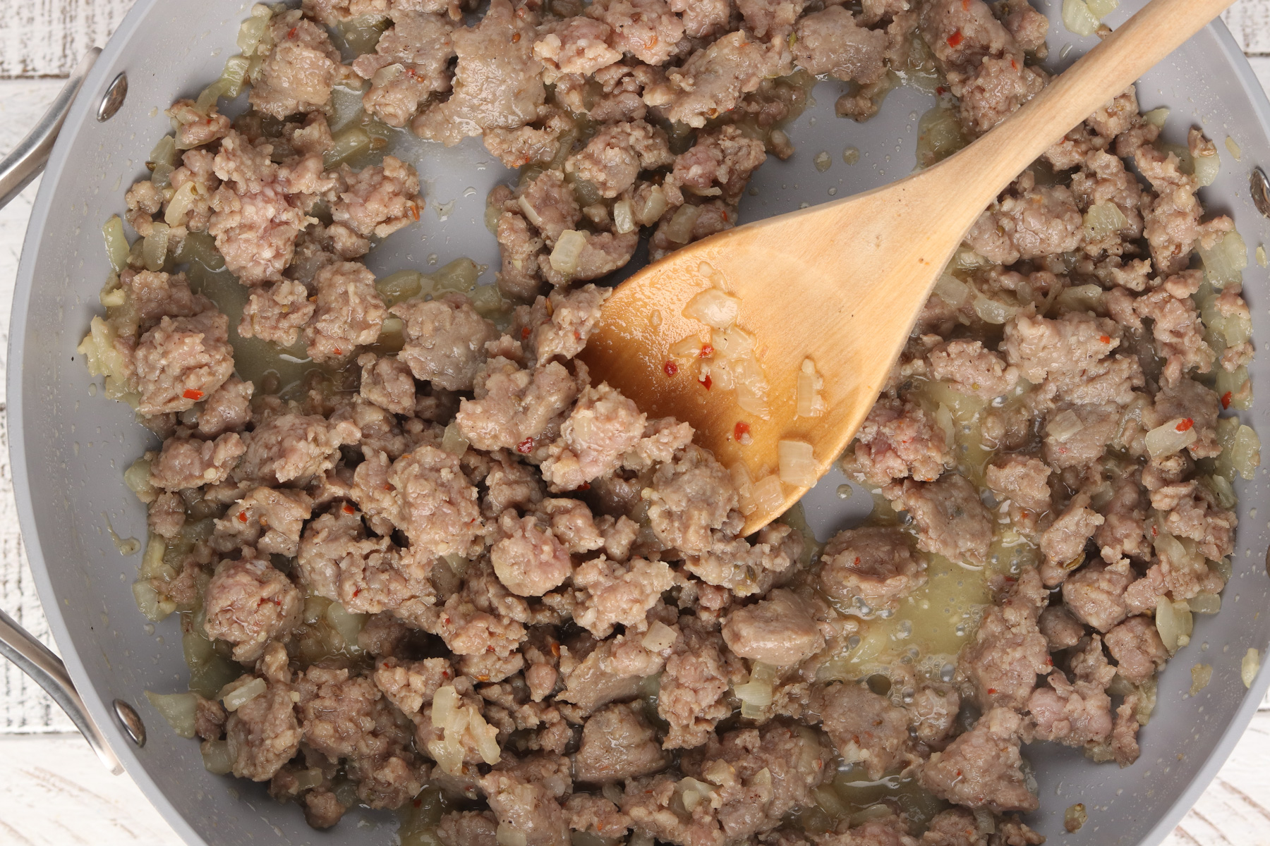 Step 2 - Meaty Marinara: Add ground sausage, salt and pepper to the pan.