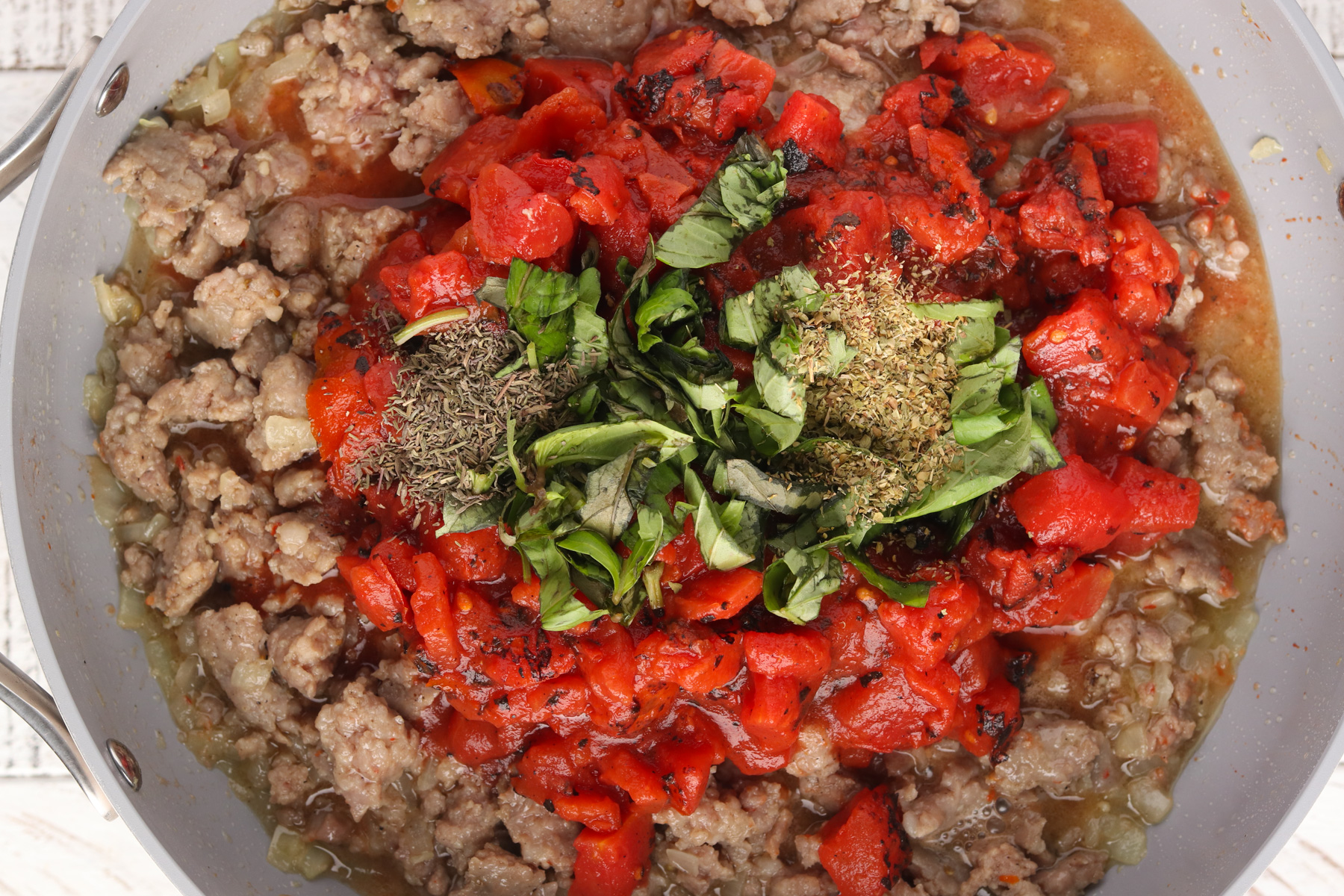  Step 3 - Add diced tomatoes, seasonings and tomato paste to meat sauce.