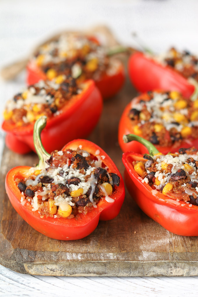 Freezer-Friendly Quinoa Stuffed Peppers on a parchment covered sheet pan.
