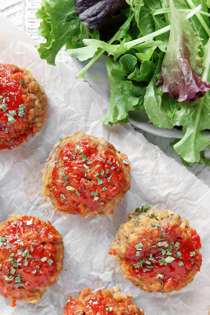 Freezer-Friendly Buffalo Chicken Meatloaf Cups on white parchment paper.