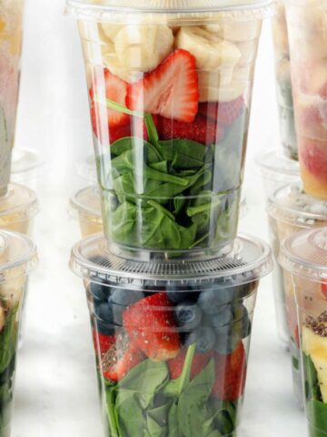 Freezer pack smoothies in clear plastic cups stacked on one another.