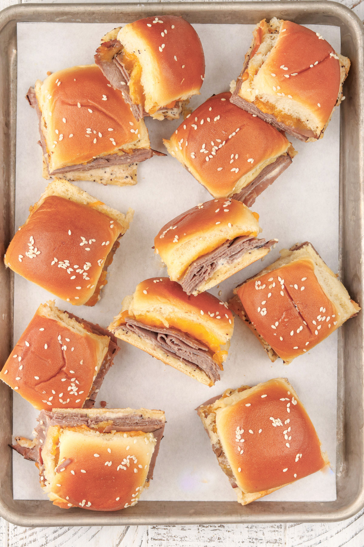 Cheddar Roast Beef Sliders on Hawaiian Rolls on a sheet pan.