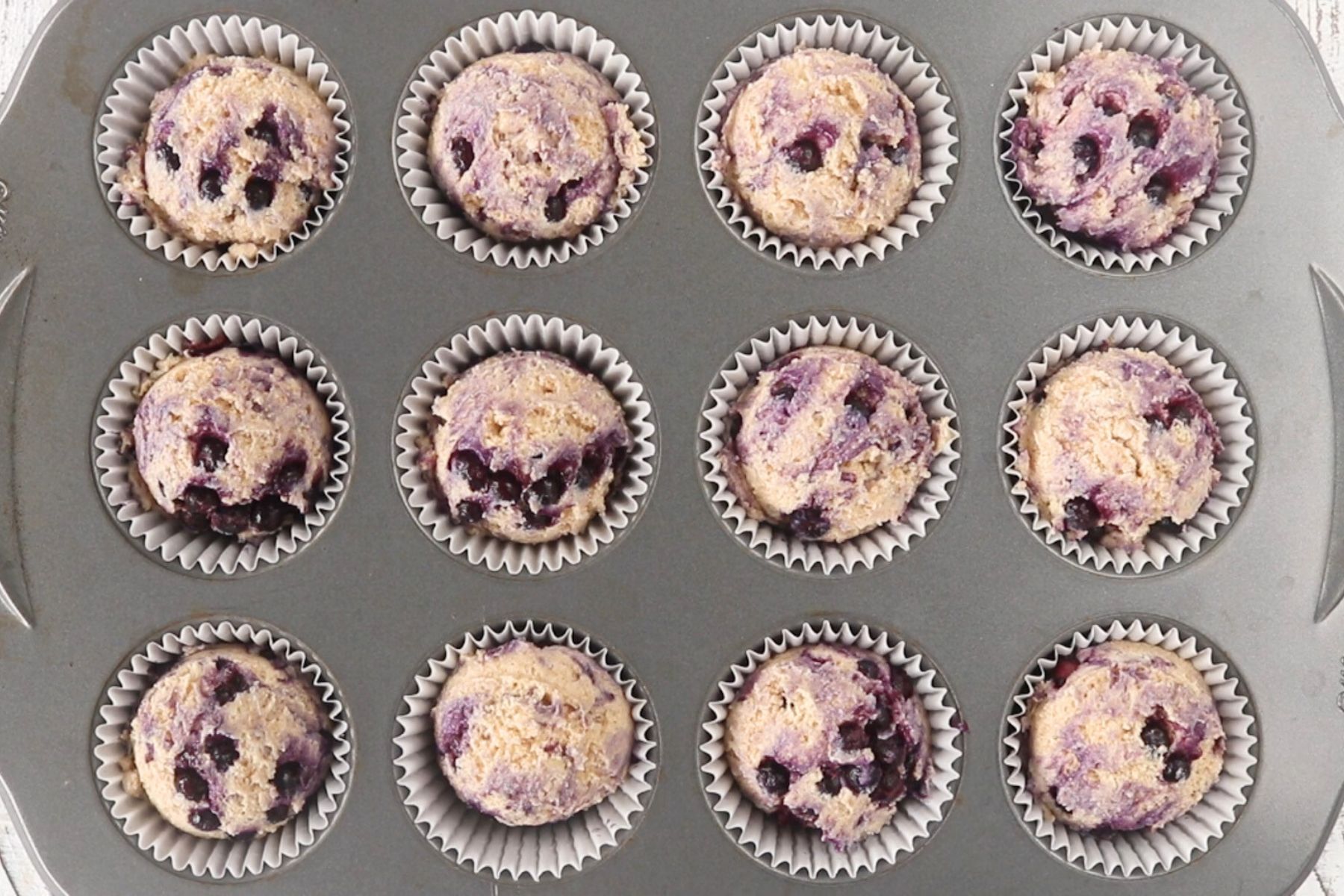 Step 5 - Blueberry Protein Muffins. Scoop batter into muffin tin cups. 