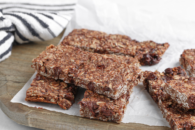 Healthy Homemade Peanut Butter Chocolate Protein Bars cooling on a wood cutting board.