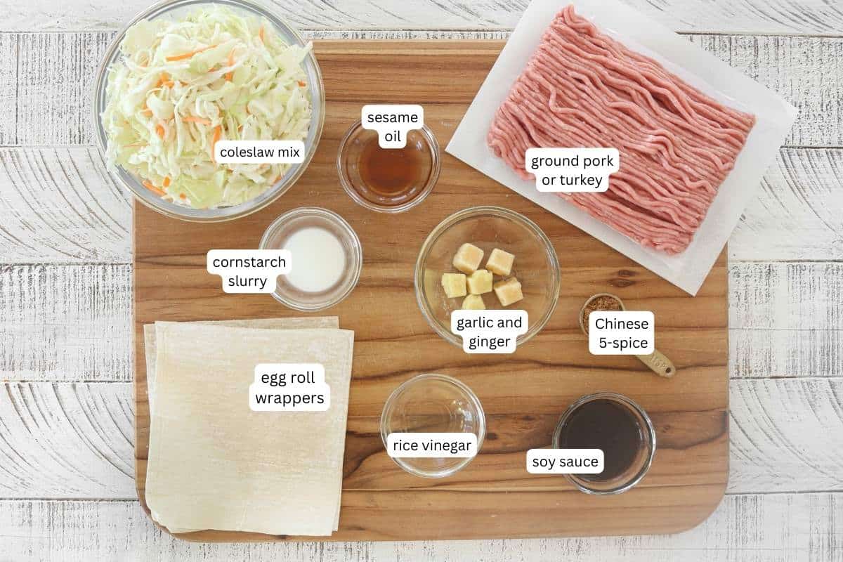 Ingredients for healthy egg rolls on a wood cutting board. 
