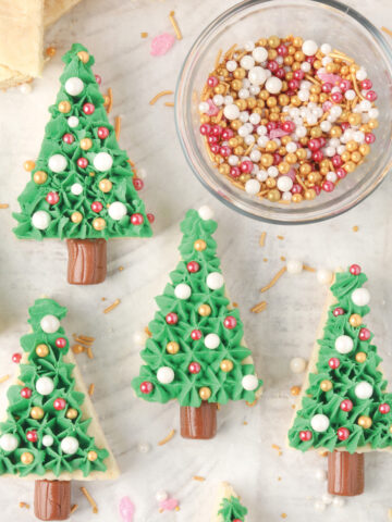 Christmas Tree Iced Sugar Cookie Bars spread on parchment paper.