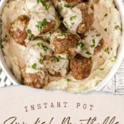Instant Pot Swedish Meatballs piled into a large white bowl of mashed potatoes.