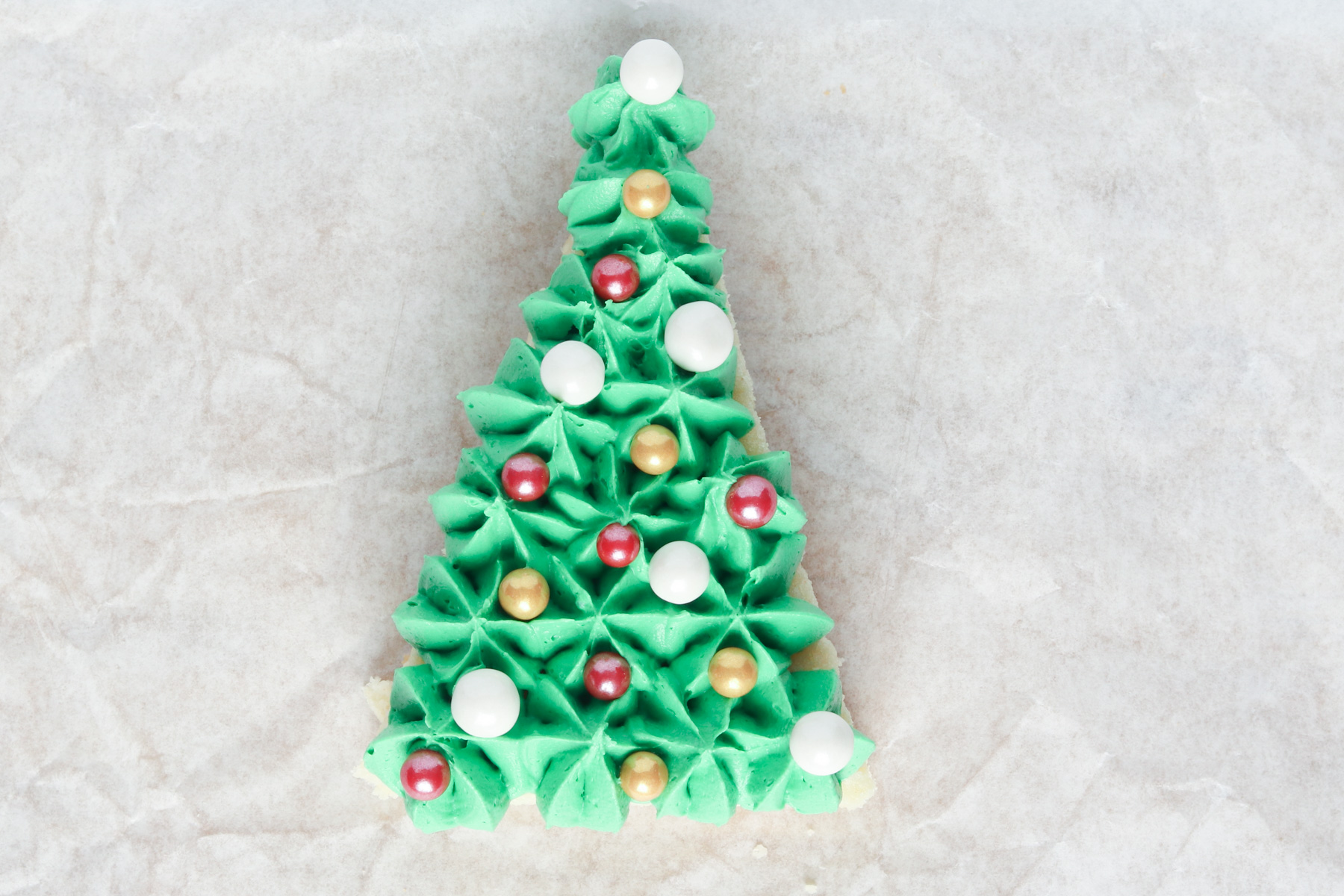 Step 10: Christmas Tree Sugar Cookie Bars. Add sprinkles (ornaments) to the tree.