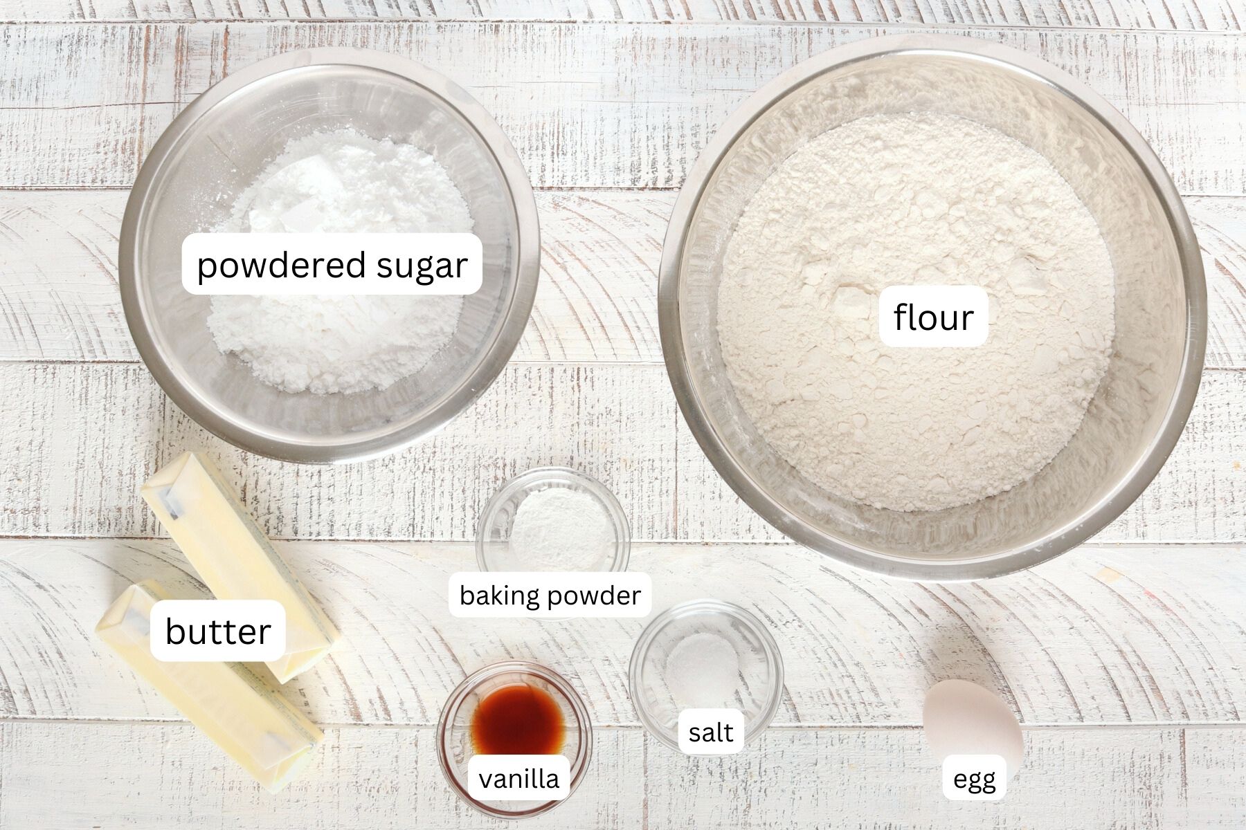 No Spread Sugar Cookie Ingredients. Powdered sugar, butter, flour, baking powder, eggs, salt  and vanilla extract.