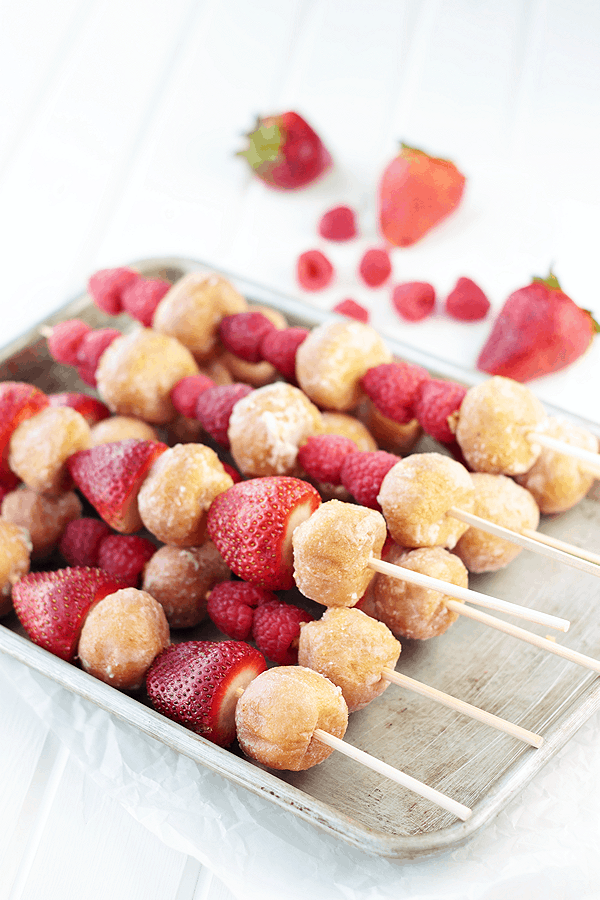 Strawberries, Raspberries and glazed donuts on a fruit kabob stick.