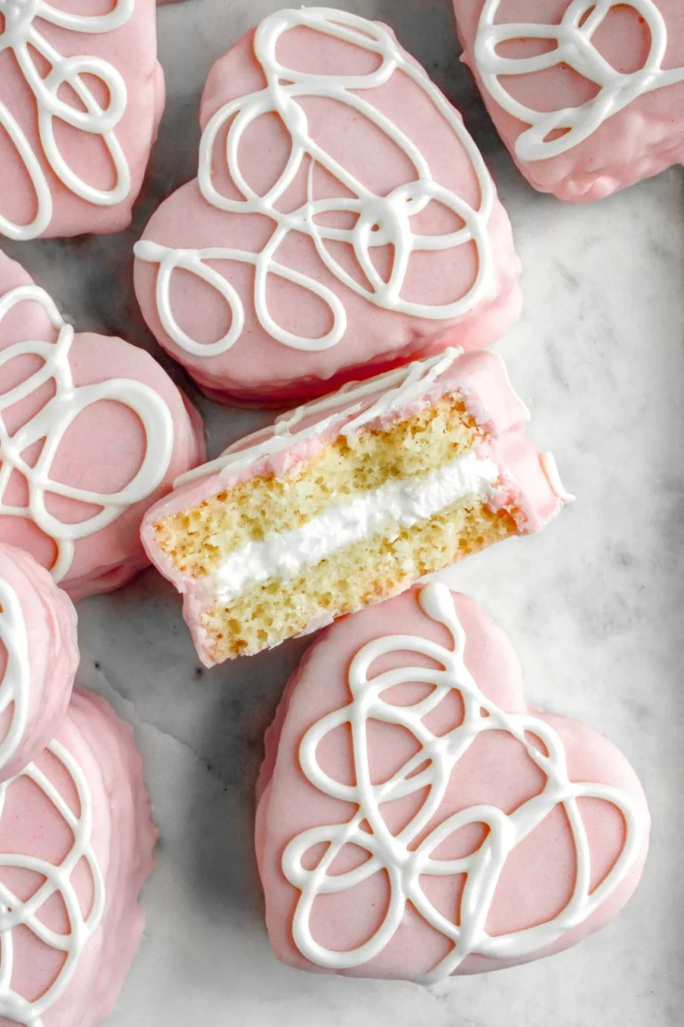 Mini Valentine's Day Cakes decorated with pink and white frosting. A cute Valentine's Day treat for classroom parties.